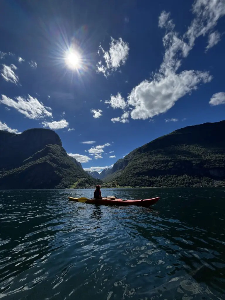 Person kayaking in front of Undredal, Norway - Kayaking - Norway fjord - hiking in Norway - kayaking - from Brussels airport