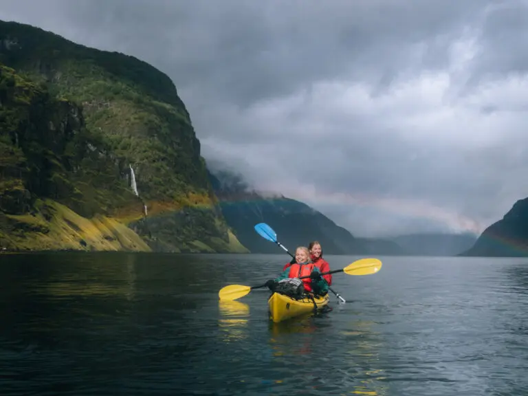 2 happy people in a double kayak, with a rainbow - Kayaking - Norway fjord - hiking in Norway - kayaking - from Brussels airport